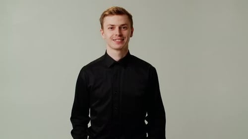 Smiling Young Adult Portrait Against Gray Background