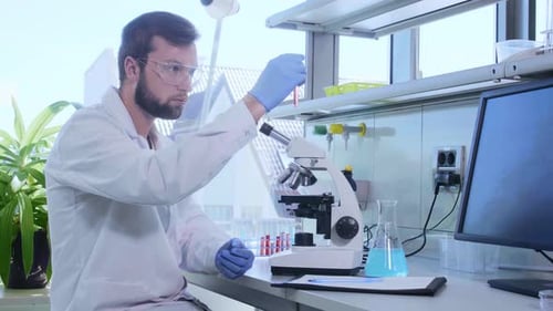 Scientist Examining Sample with Microscope in Bright Laboratory