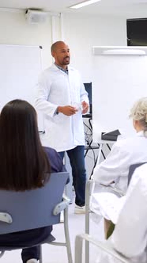 Medical Students Listening to Professor and Discussing in University Classroom