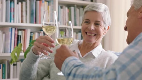 Senior Couple Toasting Wine Glasses, Smiling and Laughing