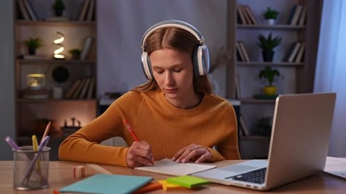 Girl Studying at Desk with Laptop and Notebook