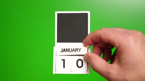 Hand Changing Date to January Tenth on Calendar