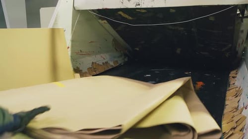 Kraft Paper Sheet on Conveyor Belt Entering Machine