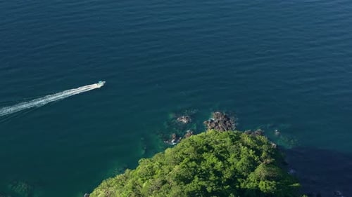 Stunning Aerial View of a Serene Coastal Landscape Featuring a Small Boat on the Water