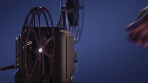 CloseUp Of Old Projector Playing 8Mm Film In A Dark Quiet Room