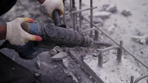 Demolition Hammer Breaking Up Concrete and Rebar