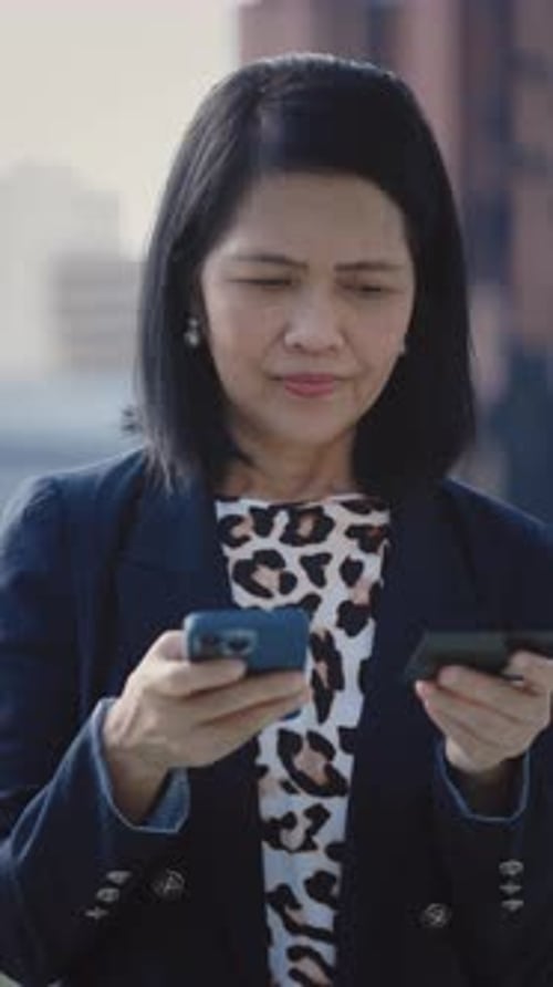 Businesswoman Using Phone and Credit Card in City