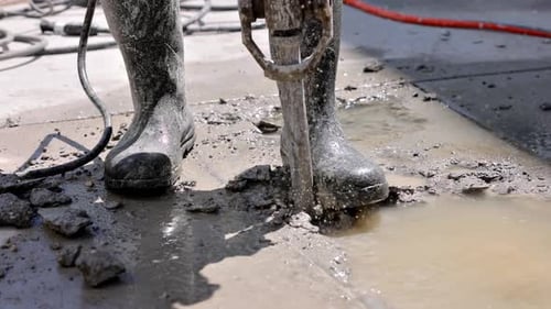 Gritty Jackhammer Breaking Concrete on Urban Street