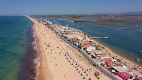 Aerial View of the Ocean Coast and Beach Boats on the Water and Tourists Relaxing on the Beach As