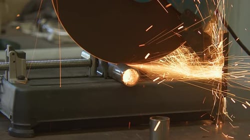 Cuting metal rod at building site. Close up of contractor cutting iron stick.