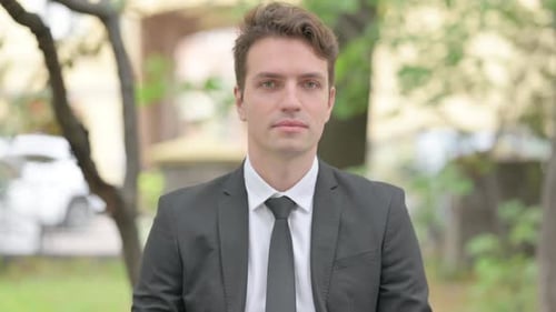 Man in Suit Stares Directly at Camera