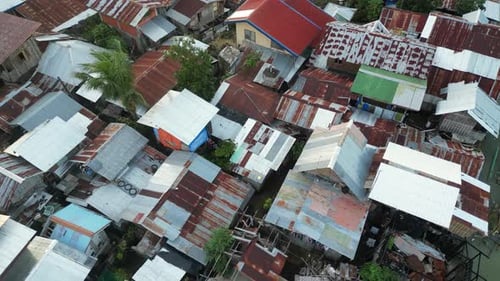 Dwelling Houses with Rusty Roofs in Small Town with Trees