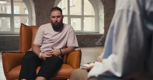 Man Talking With Therapist in Office Setting