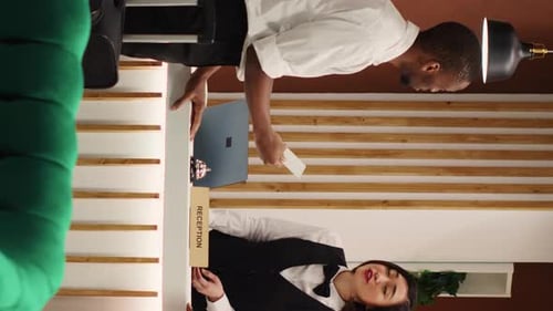 Vertical Video Hotel Staff Assisting Weary Tourists