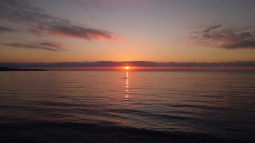 A Tranquil Drone Shot of a Stunning Sunrise Over Calm Ocean Waters with a Peaceful Horizon and