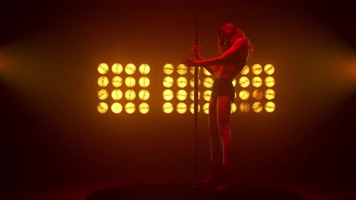 Loira gostosa mostrando dança erótica em holofotes de clubes de strip. Mulher atraente se apresentando