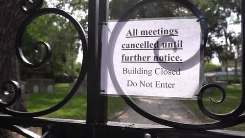 Closed sign on gates of a cemetery due to Corona virus