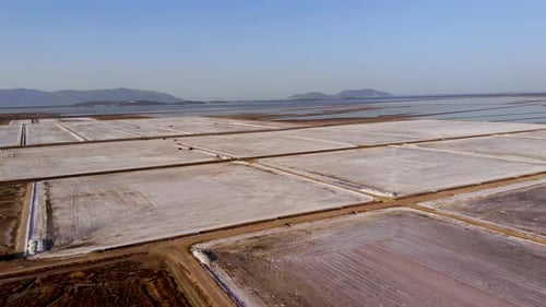 View of a salt flat factory besides the sea - Drone Shot of salt extraction