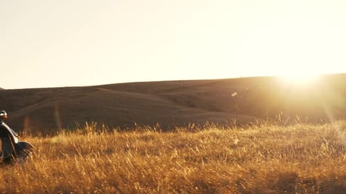 Man Riding Scooter at the Sunset