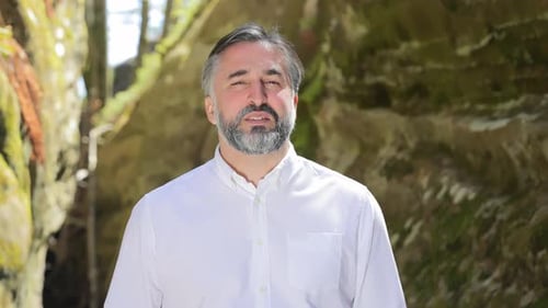 Mature Man in White Shirt Outdoors Middleaged Man with a Beard in a White Shirt Standing in a Canyon