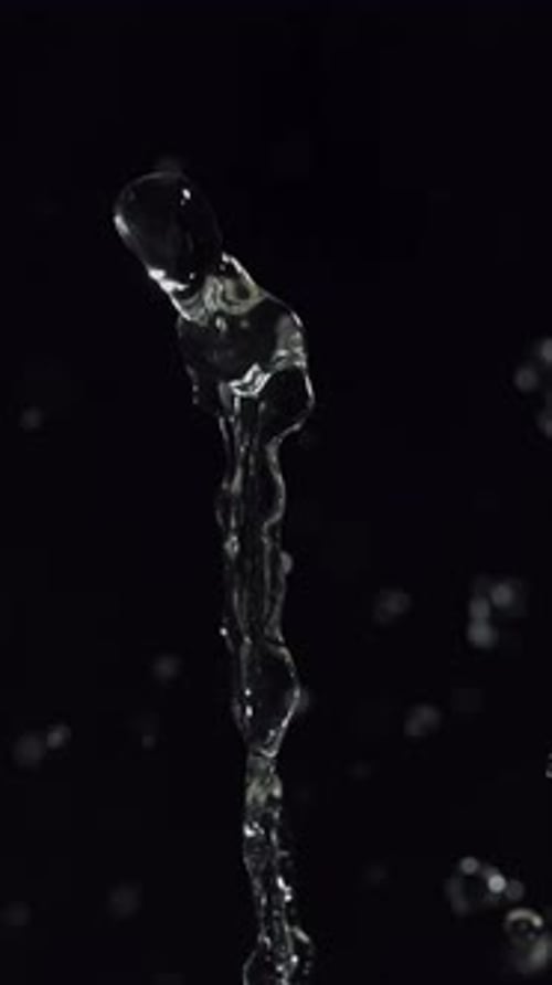 Water Drops Falling in Slow Motion on Black