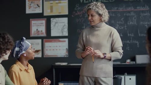 Teacher Explains Lesson to Diverse Students in Classroom