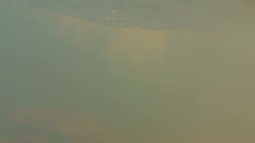 Small Waterfall Flowing Over Mossy Rocks Into Pool