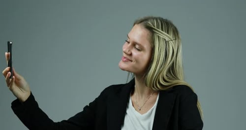 Young Woman Video Calling on Cell Phone