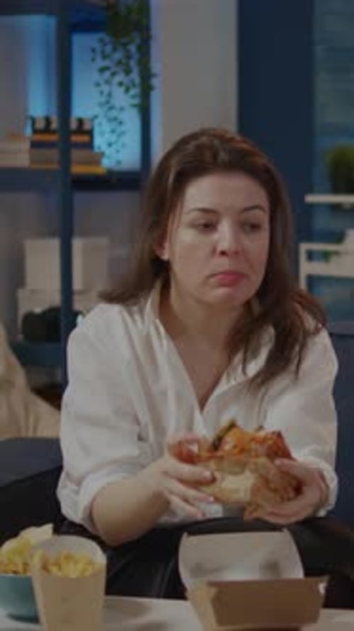Vertical Video Caucasian Woman Taking Bite From Burger and Sip of Soda