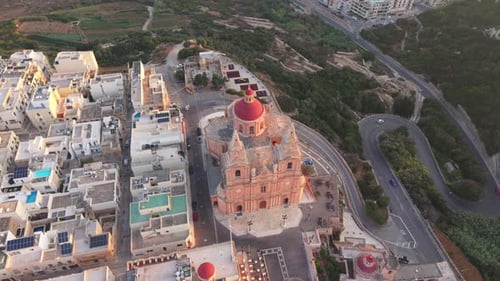 An aerial view of the Mellieha Parish Church in Malta. The baroque-style church with its red dome