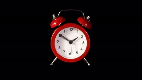 Red Alarm Clock Ticking on Black Background