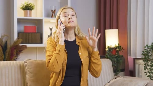 The woman is breaking up with her husband on the phone and is upset.
