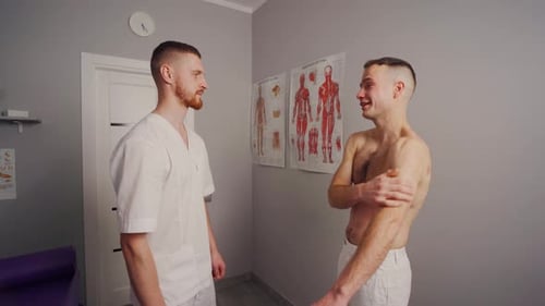 Doctor Consulting with Male Patient in Medical Clinic