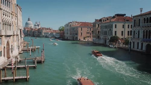 View of the Grand Canal in Venice with passing boats and historic buildings.