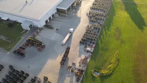 Aerial View of an Empty Flatbed Semi Truck Driving Down a Rural Highway