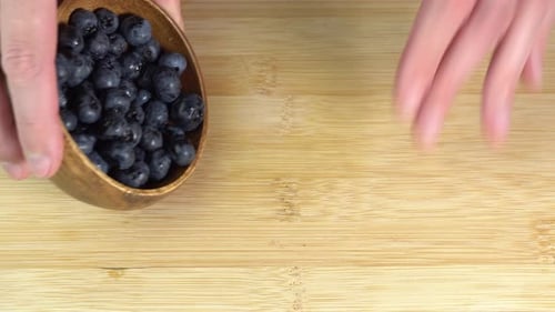 Blaubeeren gießen auf einen Holztisch. Saftige Beere, Blaubeere, Rohkostdistin