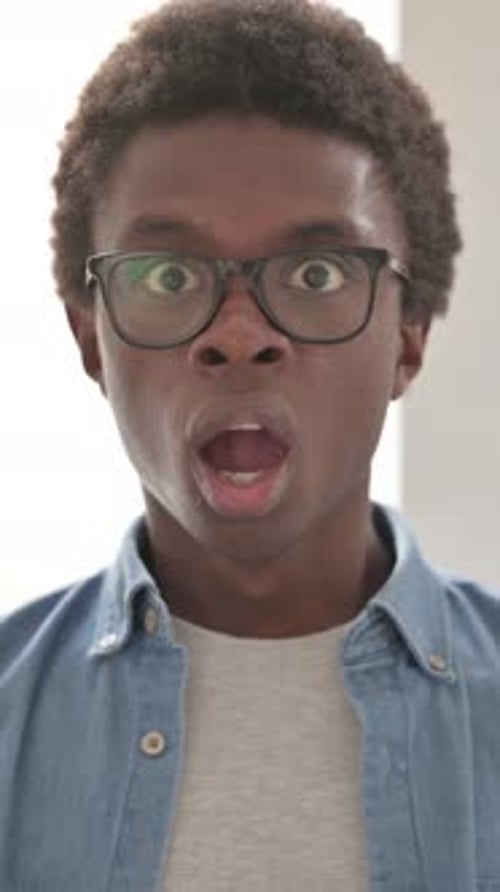 Surprised Young Man's Shocked Reaction With Hand Over Mouth
