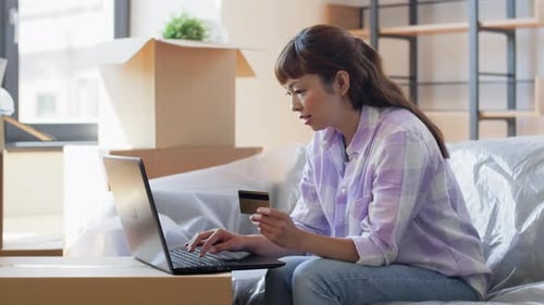 Moving, People And Real Estate Concept - Happy Smiling Asian Woman With Laptop Computer And Credi...