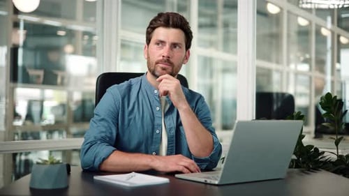 Man Working on Laptop in Modern Office