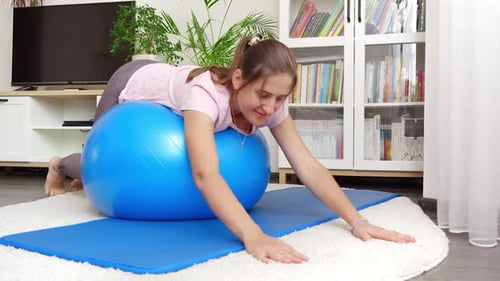 Woman Exercising with Yoga Ball at Home