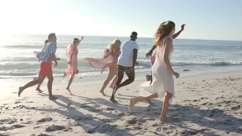 Diverse friends enjoy a lively run on the beach