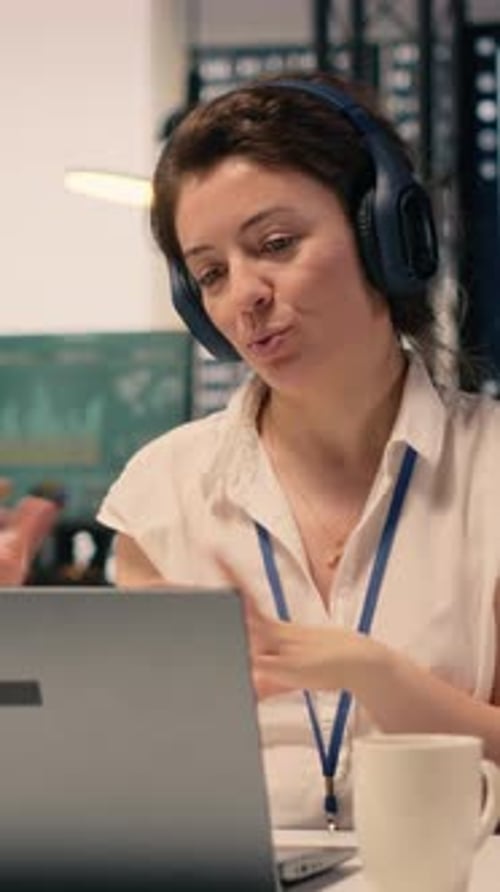Business Worker on Video Conference Meeting Waving with Headset