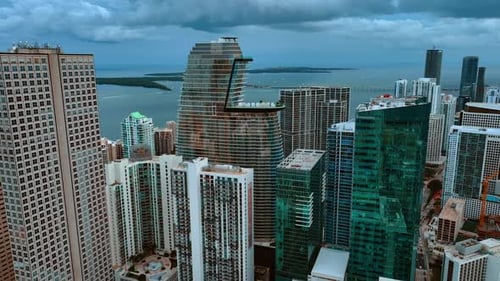Rising above the skyscrapers on the waterfront of Miami. Opening view on Atlantic Ocean