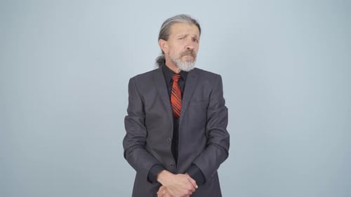 Older Man in Suit Looking Confused and Concerned
