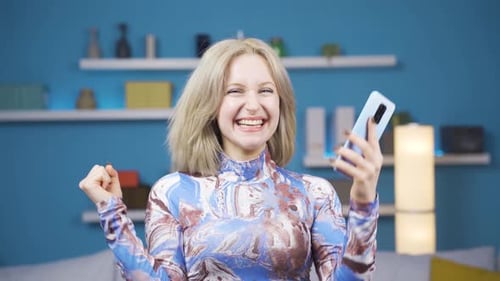 Excited Young Woman Celebrates Good News on Phone