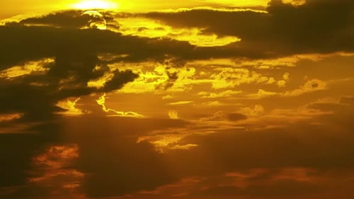 Golden Sunlight Streams Through Clouds During Sunset