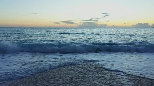 Waves Crashing on Beach at Sunrise or Sunset