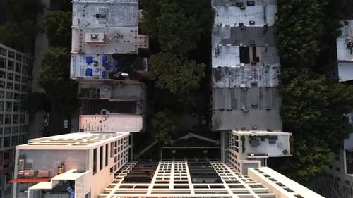 Aerial view above the rooftop of a sunlit apartment building, golden hour in New York - birds eye, d