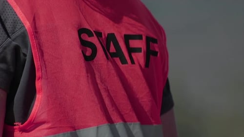 Staff writing on the back of a working person. Company man.