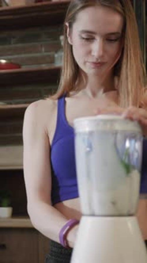 Woman Making a Smoothie in the Kitchen
